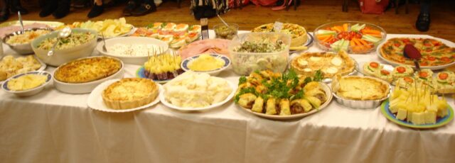 Table laden with food to share.